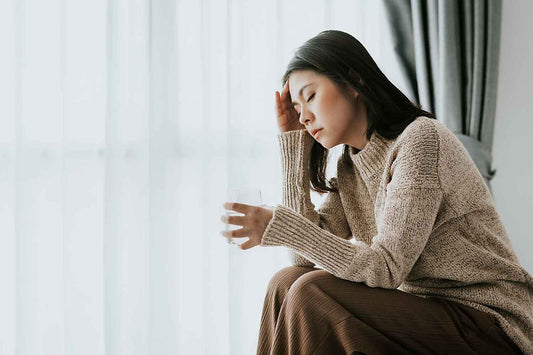 Femme qui a mal à la tête